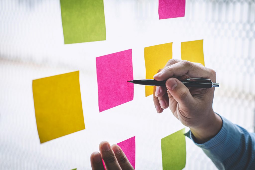 Businessman use post it notes to planning idea and business marketing strategy.